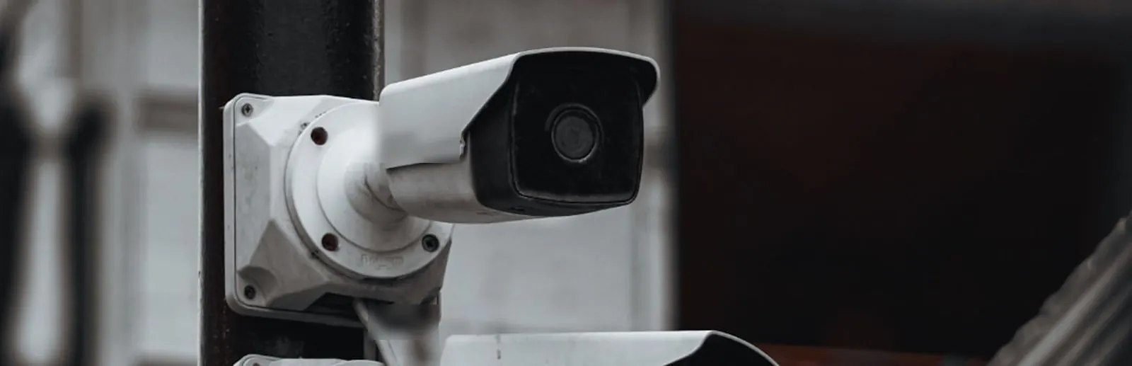 Street security camera on a city light pole, illustrating local crime rate data