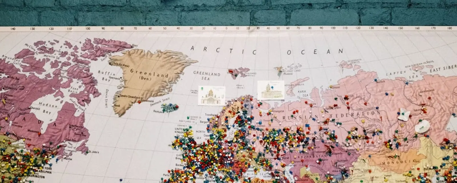 Wall clock above a pinned world map, illustrating US time zones by ZIP code