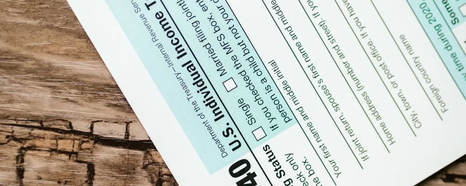 IRS Form 1040 on a wooden table, illustrating the reverse sales tax calculator