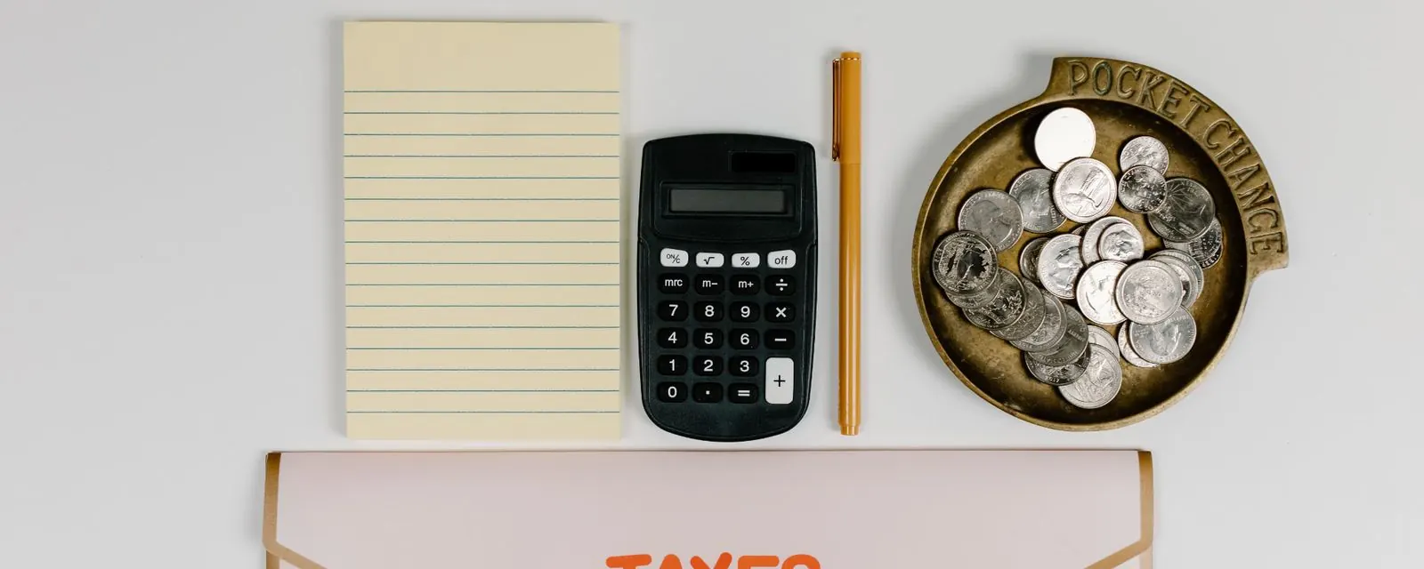 Notepad, calculator and folder marked TAXES, illustrating the sales tax calculator