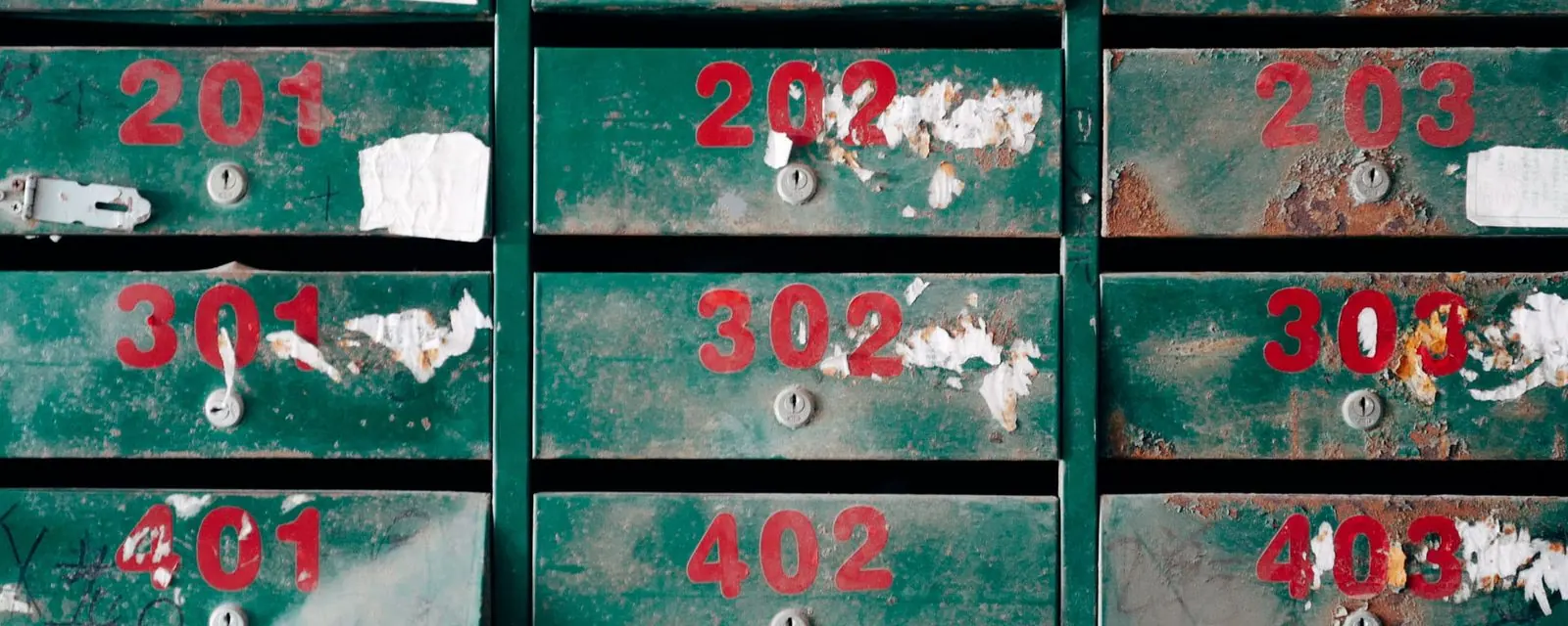Grid of numbered green mailboxes in an apartment lobby, illustrating ZIP code listings