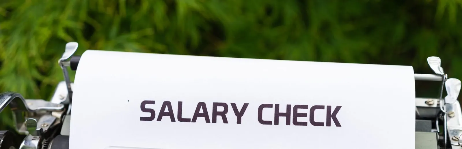 Typewriter page reading Salary Check, illustrating local salary and jobs data